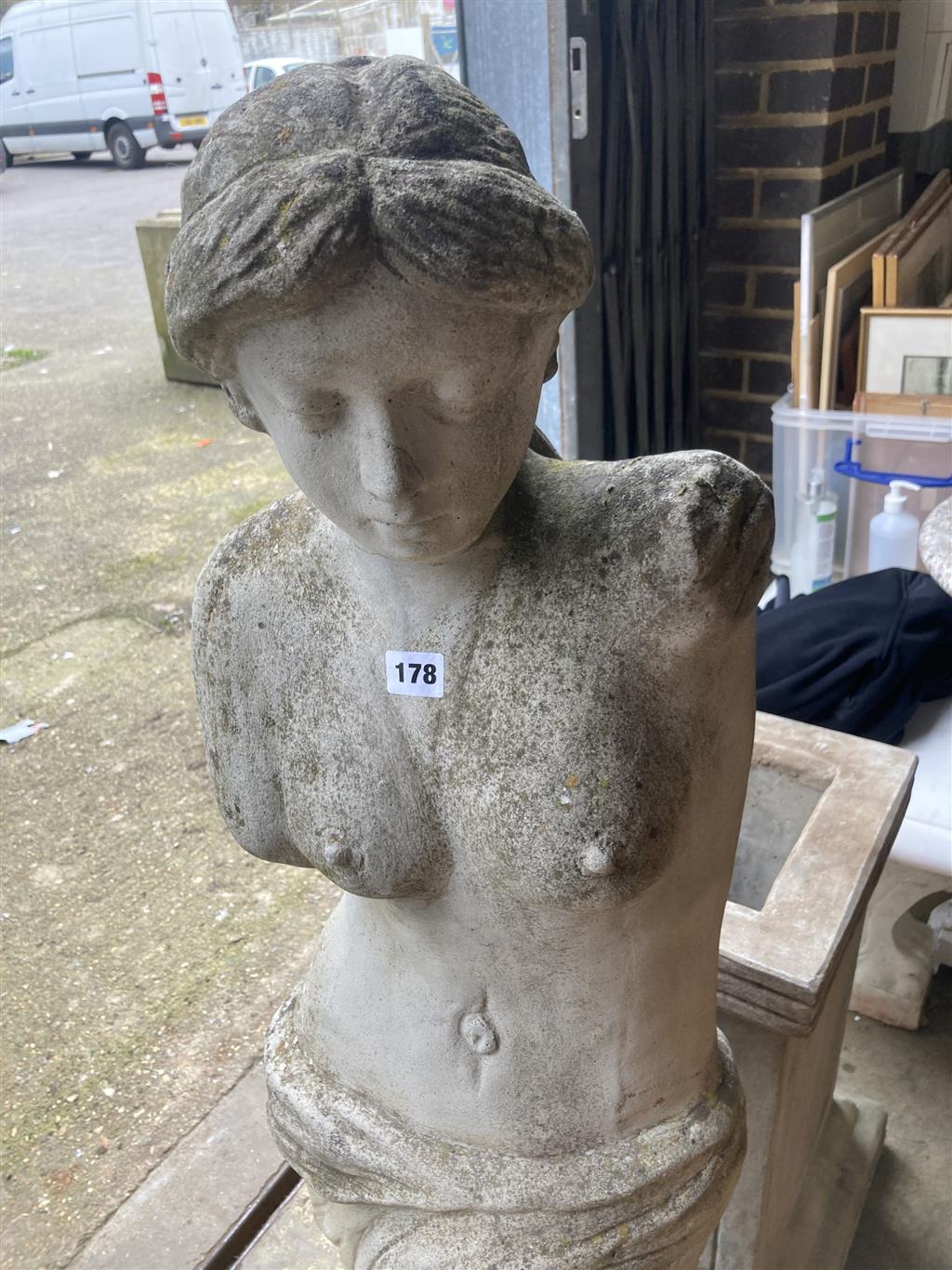 A reconstituted stone garden ornament of Venus on pedestal base, height 192cm